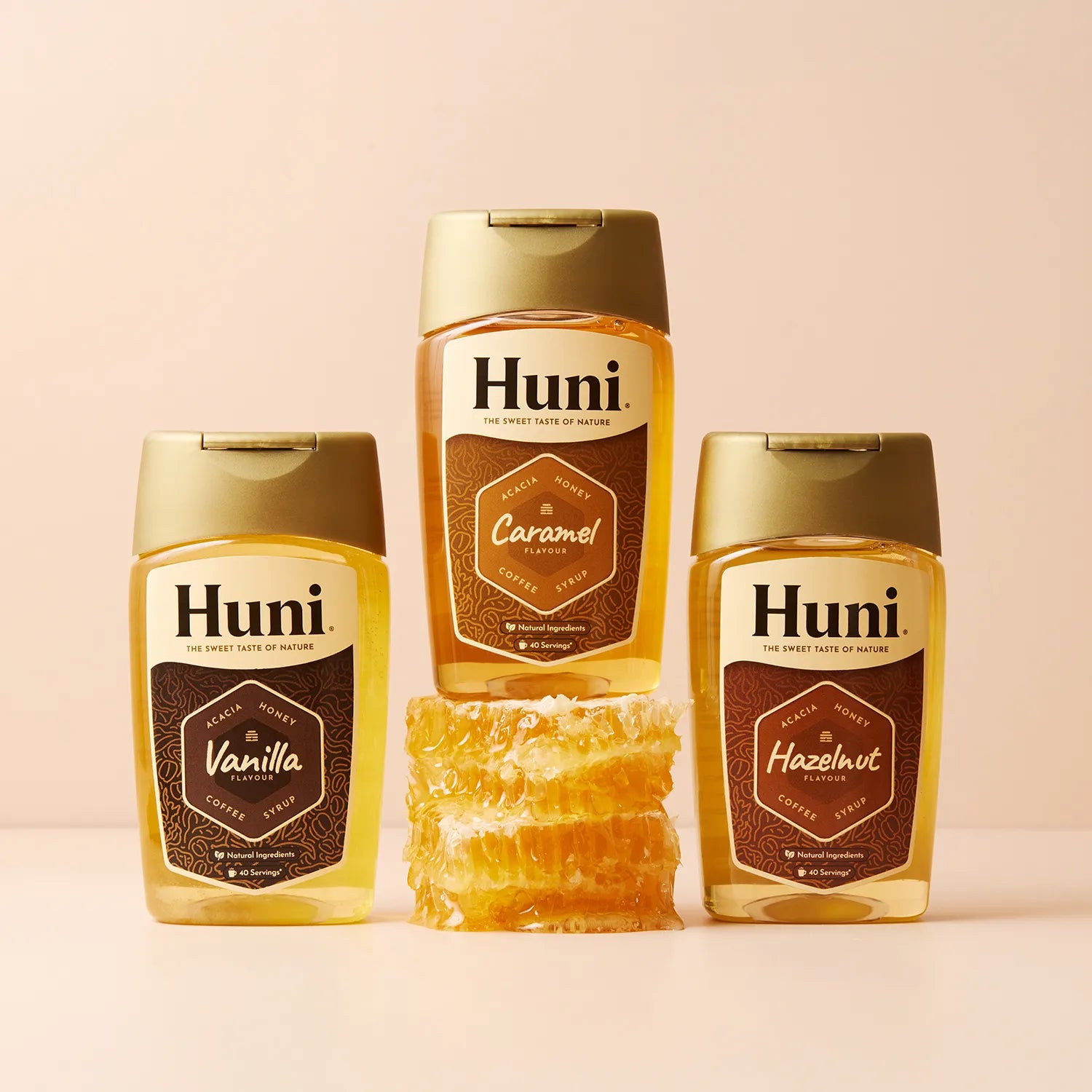 Three bottles of Huni Natural coffee syrup. Caramel, Vanilla and Hazelnut flavours.