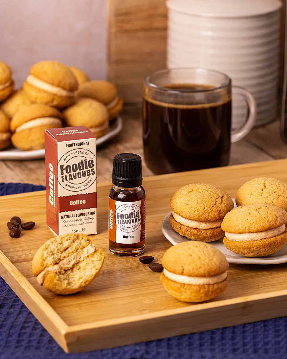 Bottle of Foodie Flavours coffee natural flavouring with cookies and a cup of coffee on a wooden tray.