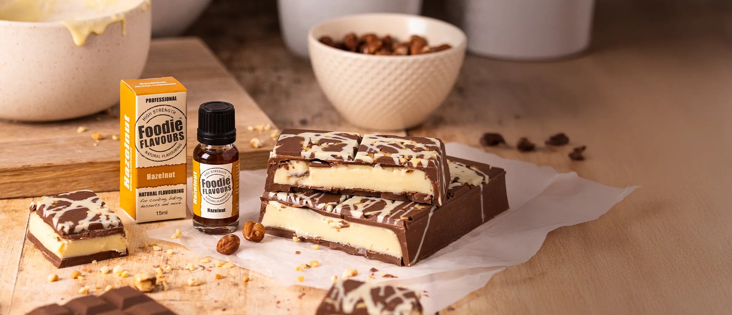 Homemade Hazelnut Stuffed Chocolate Bar. Hazelnut flavoured white chocolate filling. Chocolate making scene, bottle of Foodie Flavours Hazelnut Natural Flavouring.