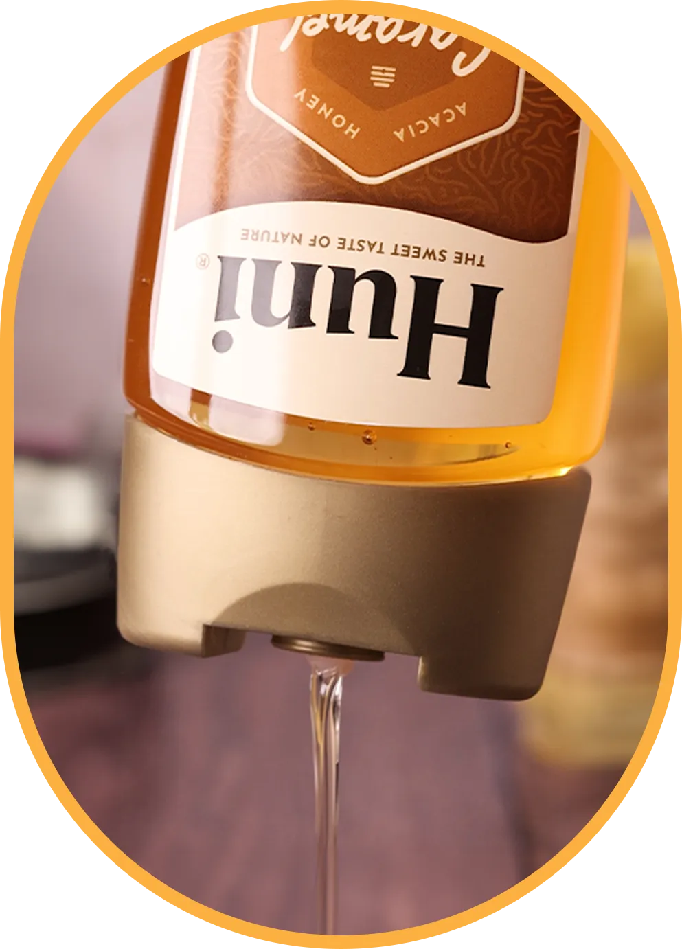 bottle of huni natural coffee syrup caramel flavour being poured onto a spoon