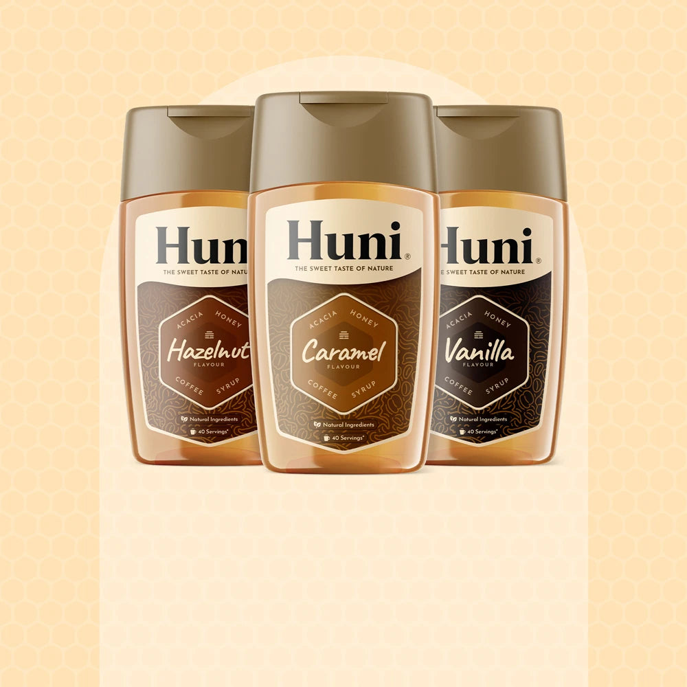 Three bottles of Huni Natural coffee syrup. Caramel, Vanilla and Hazelnut flavours.