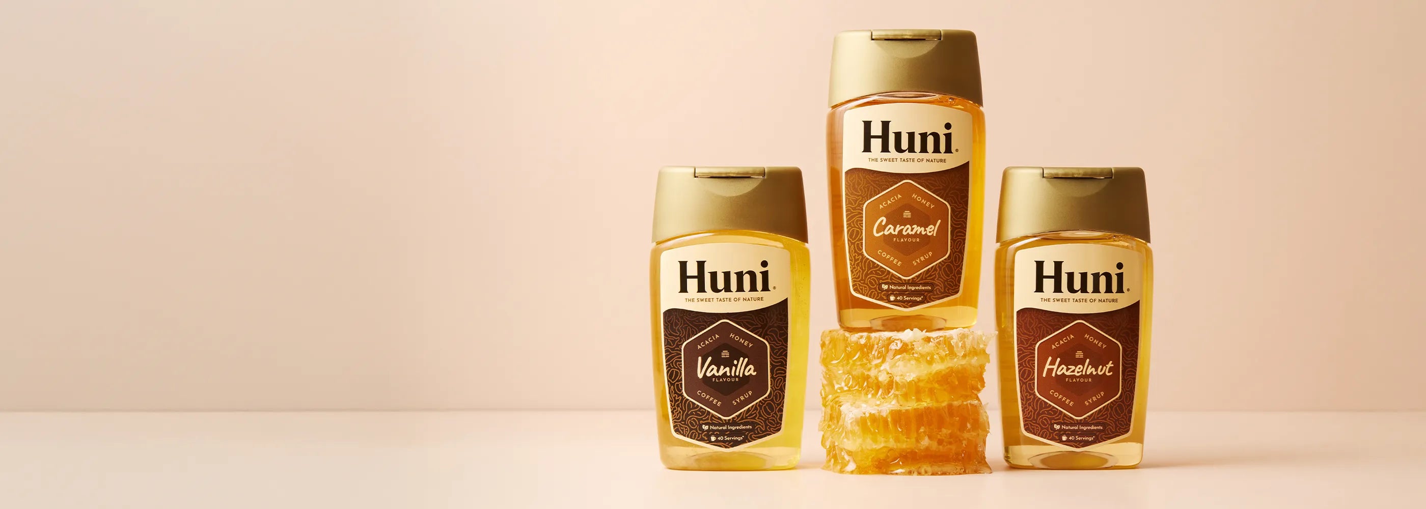 Three bottles of Huni Natural coffee syrup. Caramel, Vanilla and Hazelnut flavours.