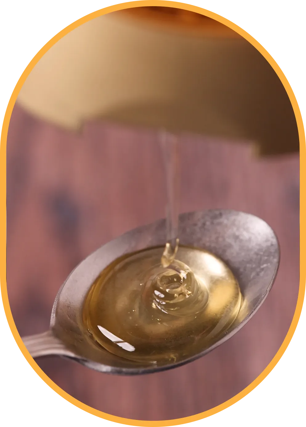huni natural coffee syrup being squeezed onto a spoon.