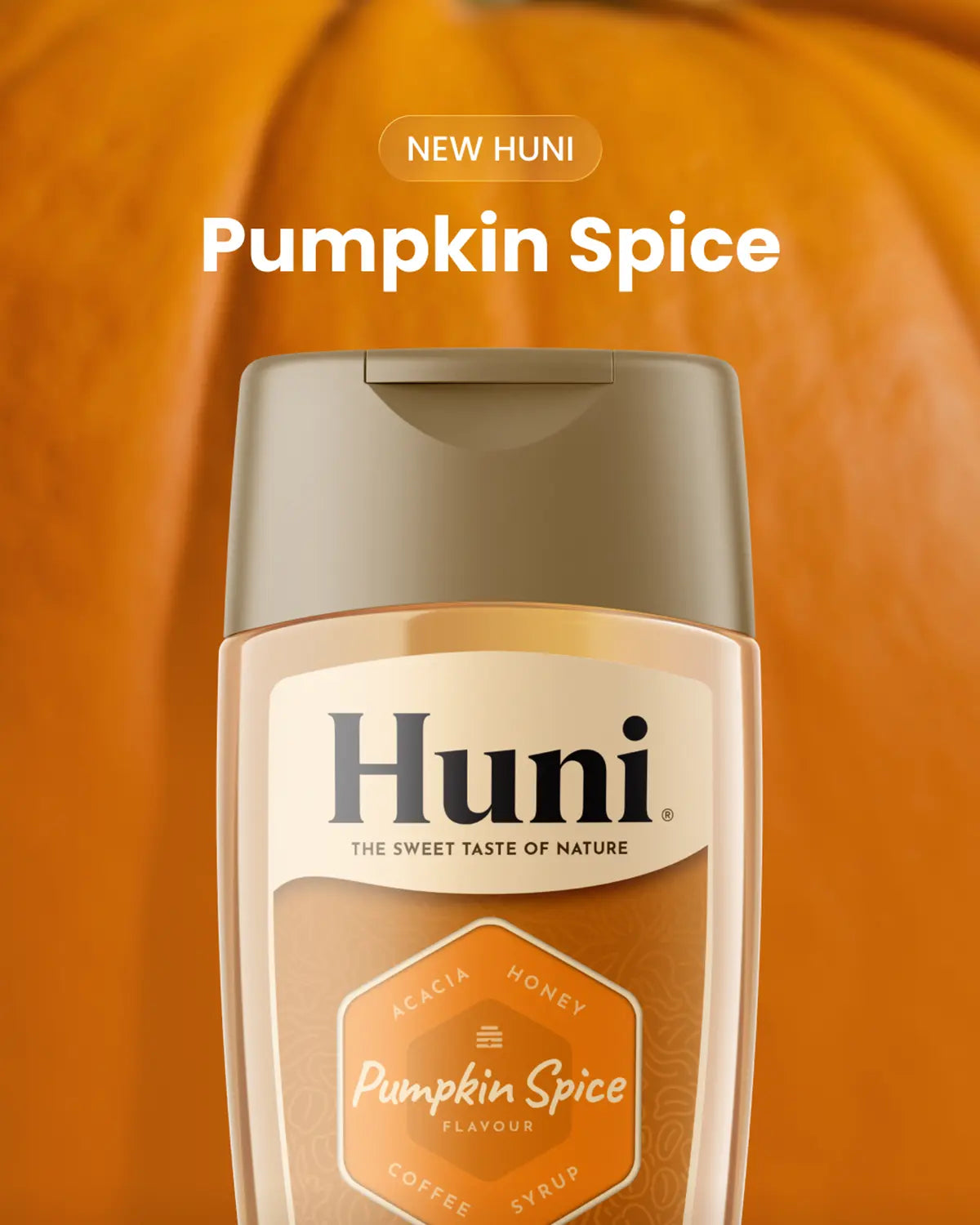 Bottle of Huni Pumpkin Spice flavoured natural coffee syrup with a pumpkin in the background