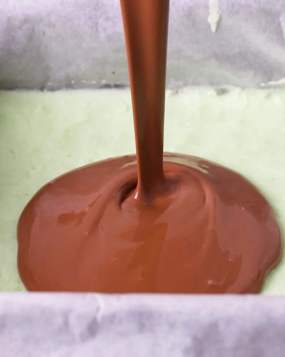 Chocolate being poured onto a baking tray