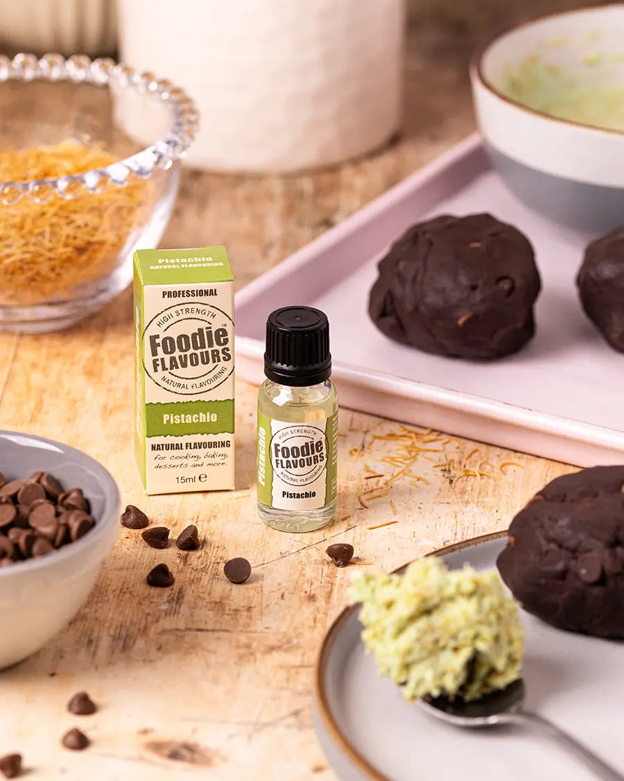 Foodie Flavours pistachio flavoring bottle with chocolate cookies and ingredients on a wooden surface.