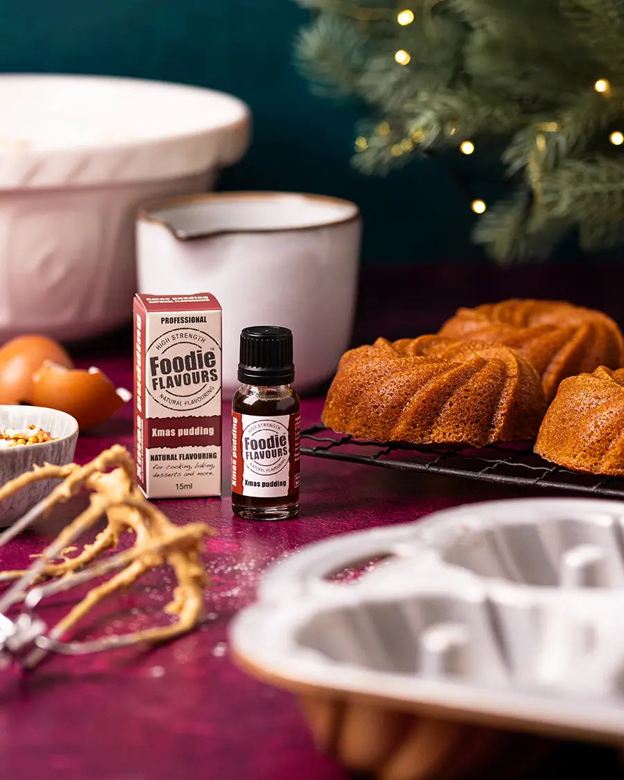 Xmas pudding food flavouring, Baking ingredients and small cakes on a table.