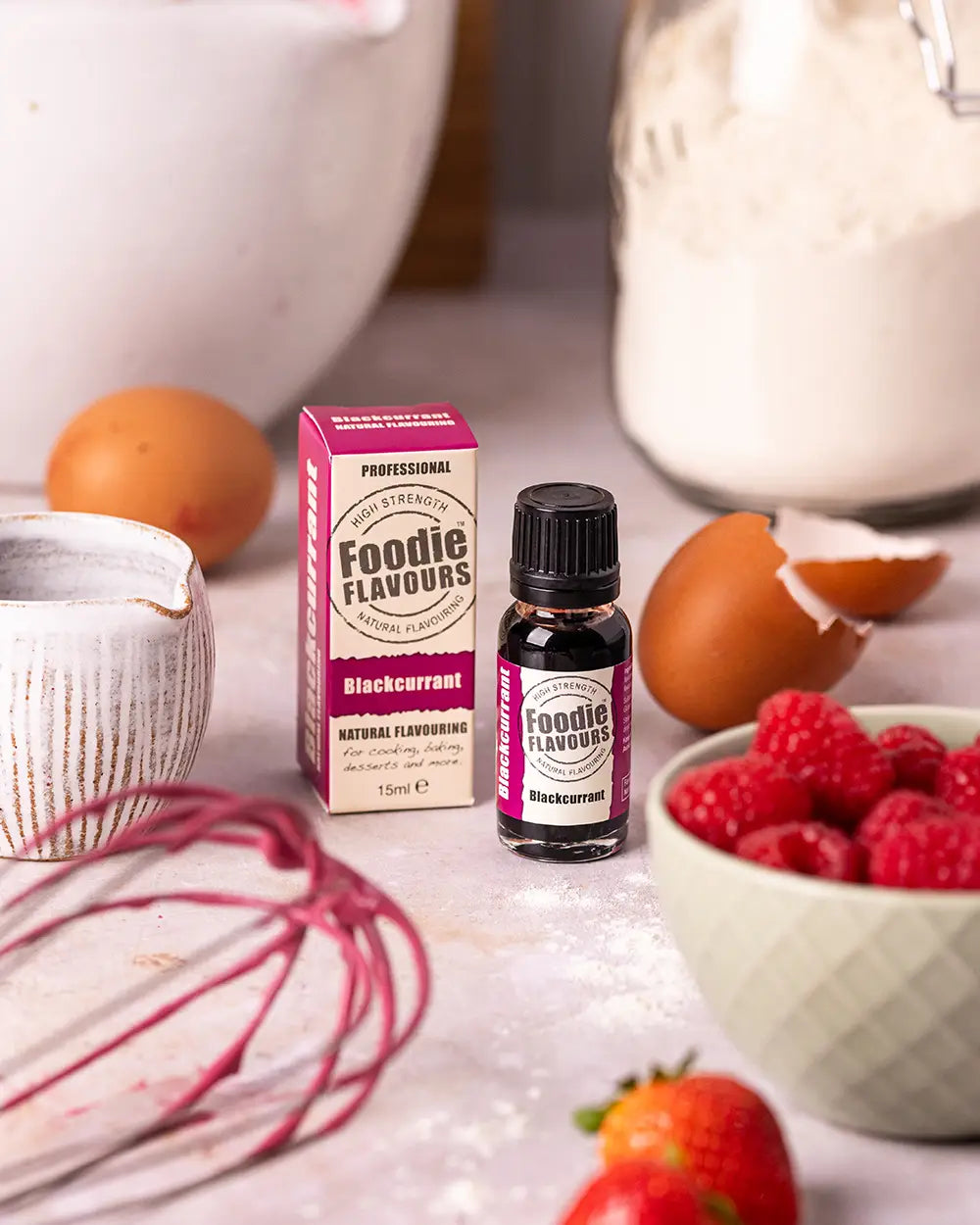 Foodie Flavours blackcurrant flavour with a box and ingredients on a kitchen counter.