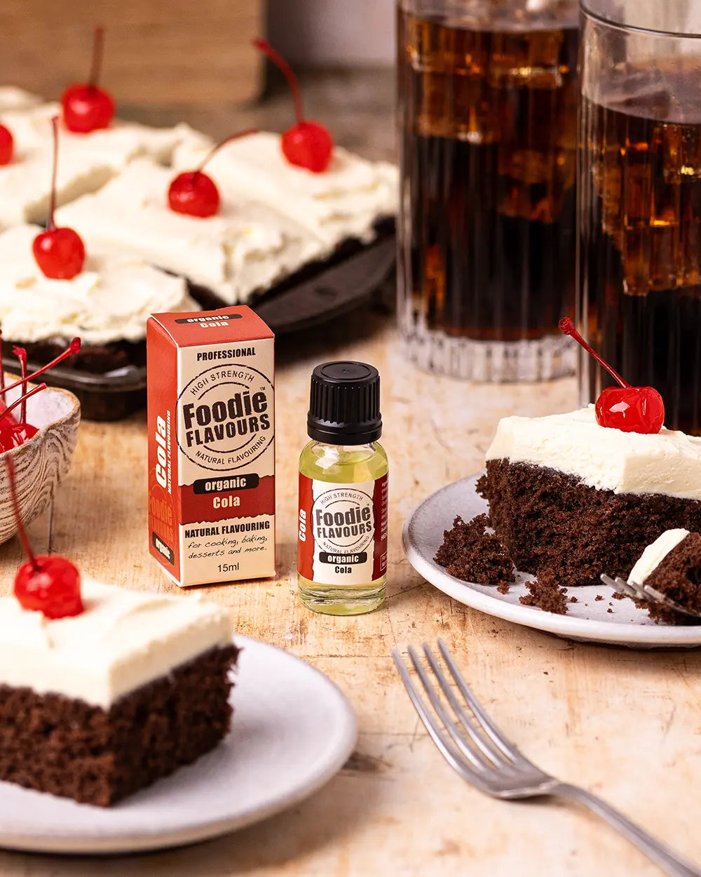 Chocolate cake with whipped cream and cherries, organic Cola flavouring.