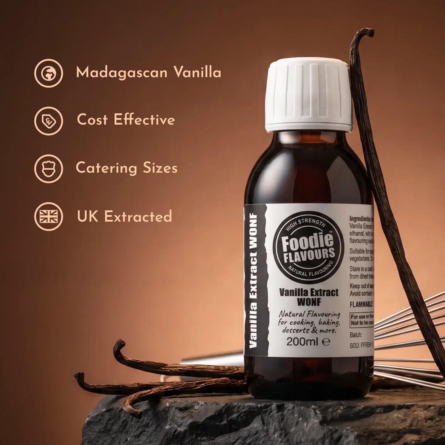 Bottle of Foodie Flavours vanilla extract with vanilla beans on a brown background