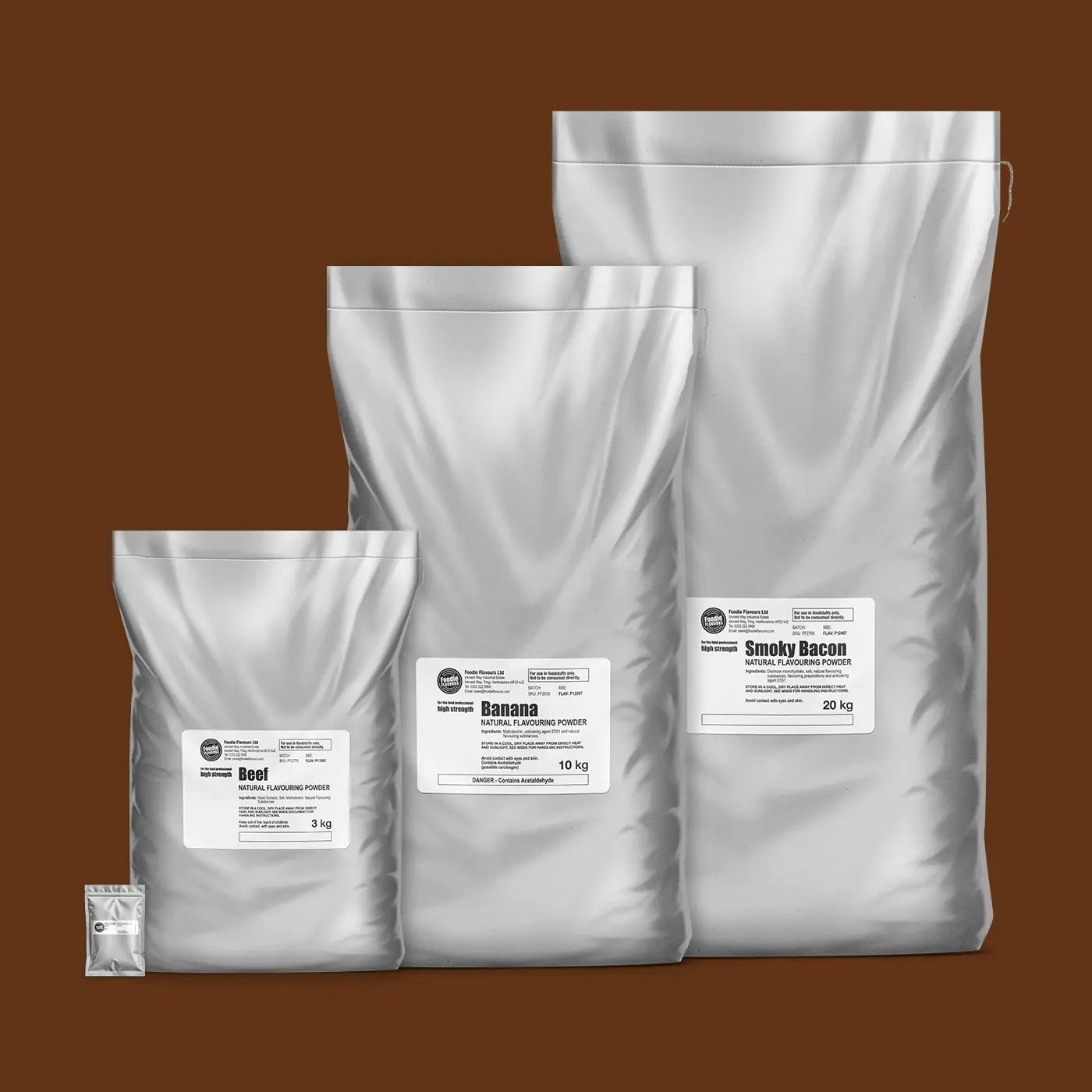 Four silver bags of natural flavouring powders, 50g, 3kg Beef, 10kg Banana, 20kg Smoky Bacon