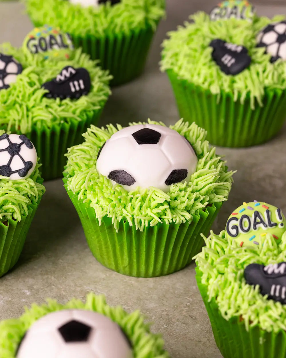 Apple flavoured football themed cupcakes with bright green piped grass