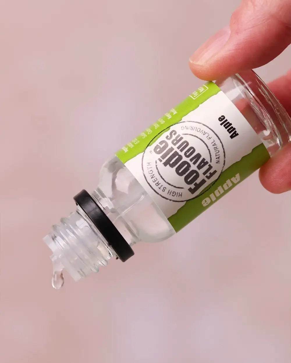 bottle foodie flavours apple essence held inverted drops being dispensed